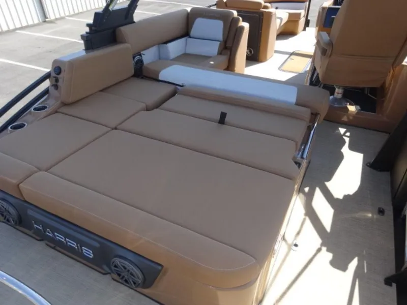 Slide: The Image of Luxurious seating on 2025 Harris Solstice 250 pontoon boat, featuring spacious tan upholstery. - 13