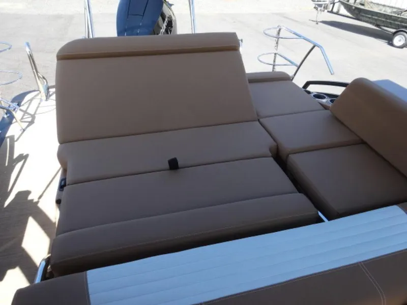 Slide: The Image of 2025 Harris Solstice 250 boat with tan cushioned seating and sleek design. - 14