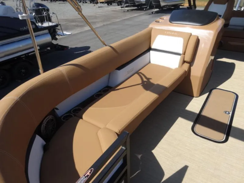 Slide: The Image of 2025 Harris Solstice 250 boat interior with tan seating and cup holders. - 4