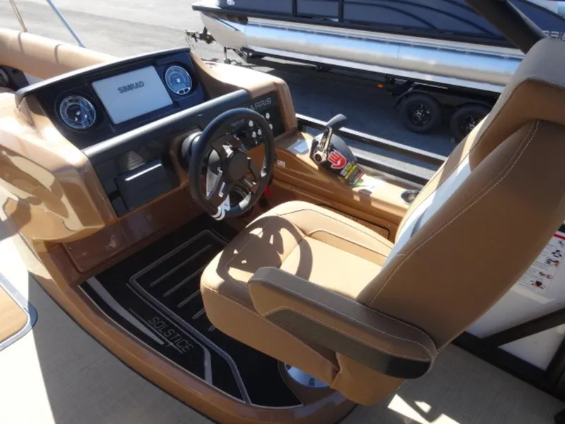 Slide: The Image of 2025 Harris Solstice 250 boat cockpit with modern steering and controls. - 9