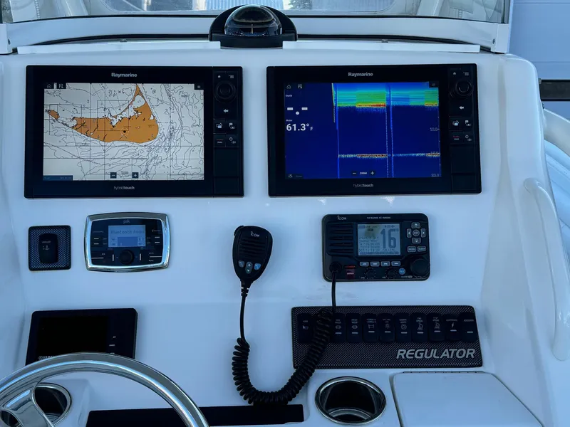 Slide: The Image of 2017 Regulator 25 CC boat dashboard with navigation and communication equipment. - 11
