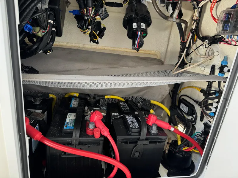Slide: The Image of 2017 Regulator 25 CC boat battery compartment with wiring and connections. - 13
