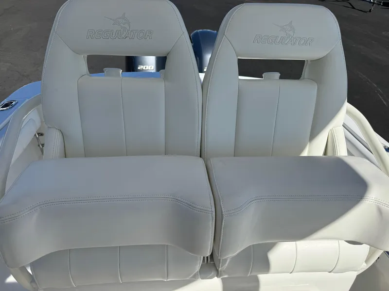 Slide: The Image of 2017 Regulator 25 CC boat seats, white leather, dual seating. - 14