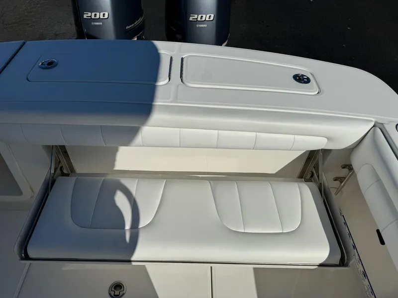 Slide: The Image of 2017 Regulator 25 CC boat with white cushioned seating and twin 200 Yamaha engines. - 17