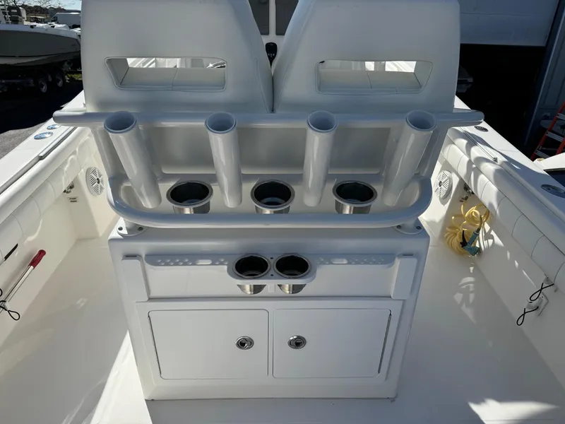 Slide: The Image of 2017 Regulator 25 CC boat interior with rod holders and storage compartments. - 19