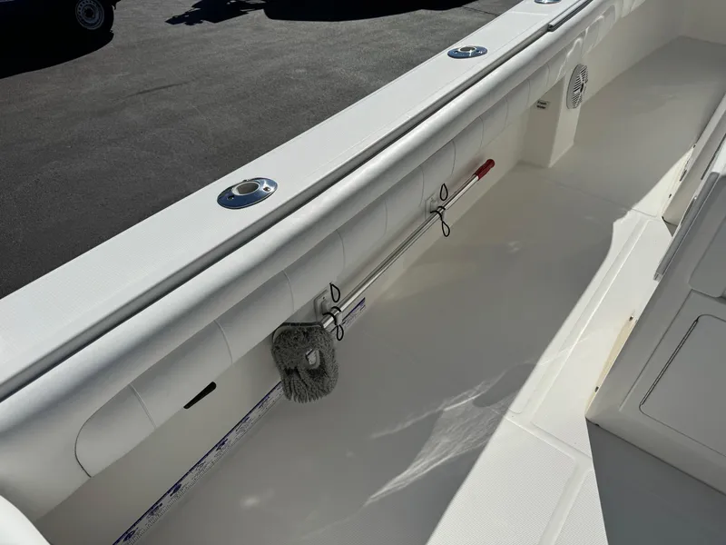 Slide: The Image of 2017 Regulator 25 CC boat interior with clean white deck and storage features. - 21