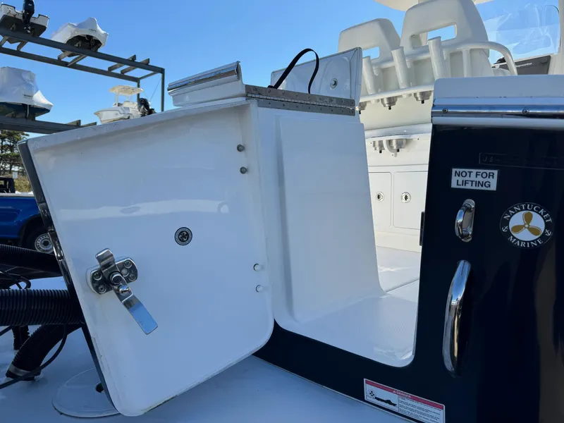 Slide: The Image of 2017 Regulator 25 CC boat with open storage compartment and marine equipment. - 24