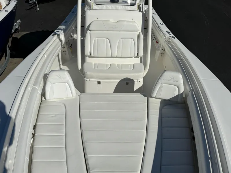 Slide: The Image of 2017 Regulator 25 CC boat interior with white cushioned seating. - 6