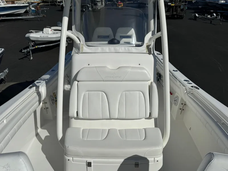 Slide: The Image of 2017 Regulator 25 CC boat interior with white seating and console. - 7