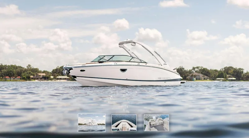 The Image of 2025 Regal LX6 boat displayed outdoors on wooden supports. - 0