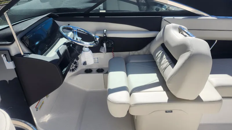 Slide: The Image of Interior of 2025 Regal LX6 boat with modern steering and seating. - 12