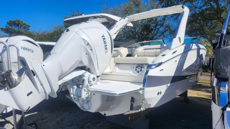Slide: The Image of 2025 Regal LX6 boat with Yamaha outboard motor, sleek design, and spacious seating. - 2