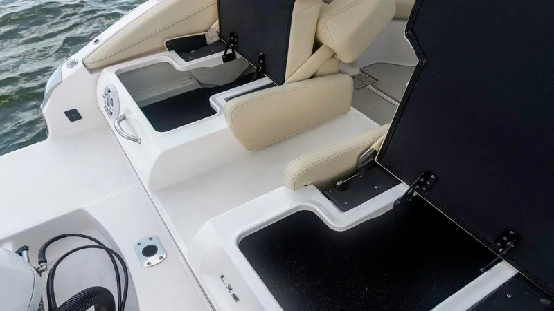 Slide: The Image of 2025 Regal LX6 boat interior with beige seating and storage compartments. - 21