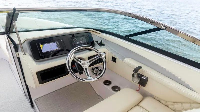 Slide: The Image of 2025 Regal LX6 boat cockpit with modern steering and navigation system. - 23