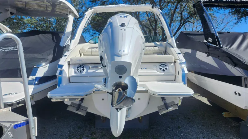 Slide: The Image of 2025 Regal LX6 boat, rear view, showcasing outboard motor and seating area. - 3