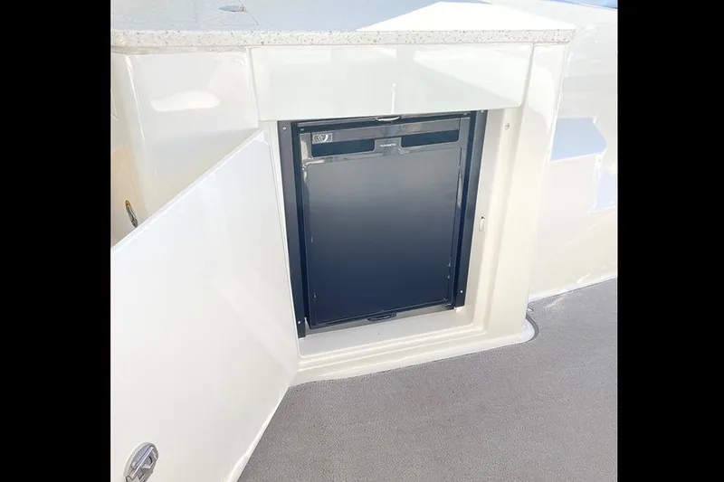 Slide: The Image of Open storage compartment on 2019 Sea Ray 350 Sundancer boat. - 12