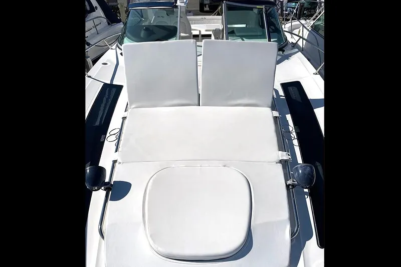 Slide: The Image of 2019 Sea Ray 350 Sundancer boat with white sunbathing deck and seating area. - 4