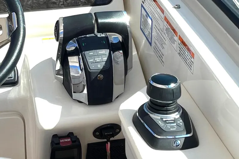 Slide: The Image of Control panel of a 2019 Sea Ray 350 Sundancer boat, featuring throttle and joystick. - 6