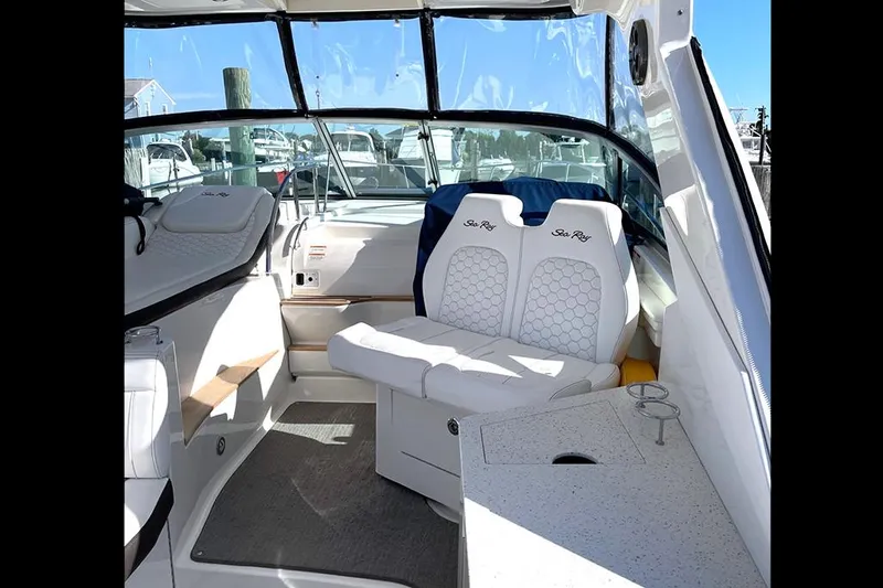 Slide: The Image of Interior of 2019 Sea Ray 350 Sundancer boat with white seating and helm. - 8
