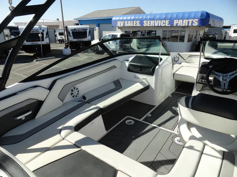 Slide: The Image of 2017 Yamaha AR195 boat interior at RV sales lot, featuring sleek seating and modern design. - 14