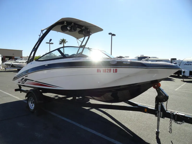 Slide: The Image of 2017 Yamaha AR195 boat on trailer in sunny parking lot. - 4