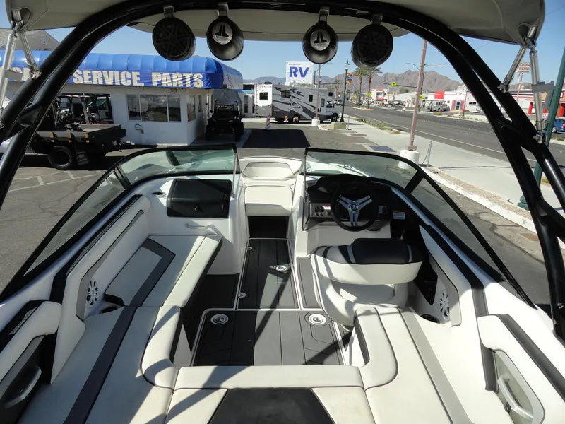 Slide: The Image of 2017 Yamaha Boats AR195 interior with seating and dashboard, parked near service area. - 6