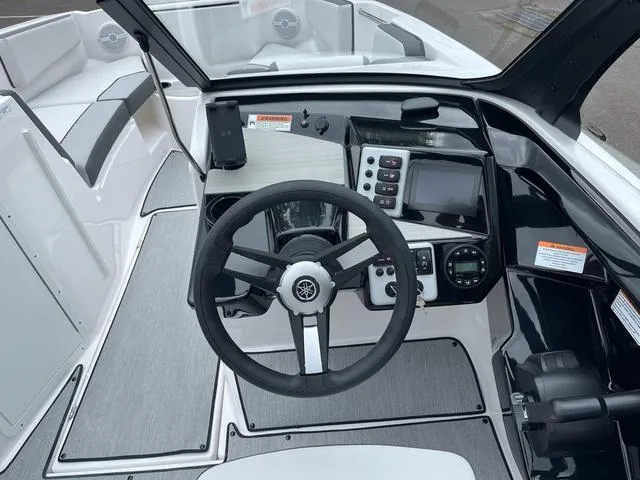 Slide: The Image of 2025 Yamaha Boats AR220 cockpit with steering wheel and control panel. - 6