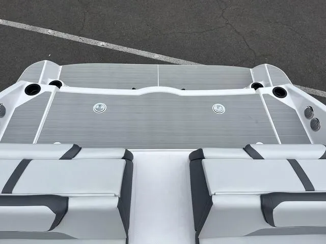 Slide: The Image of 2025 Yamaha Boats AR220 swim platform with cushioned seating and cup holders. - 9