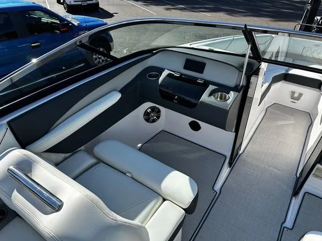 Slide: The Image of 2021 Regal LS4 boat interior with sleek seating and modern dashboard design. - 8