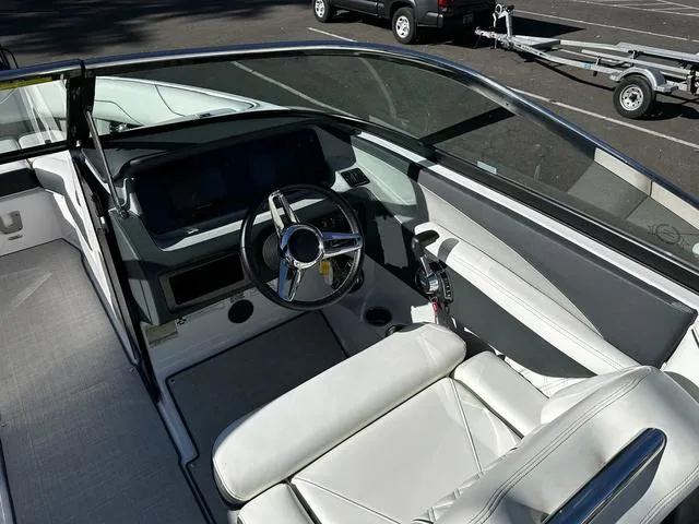 Slide: The Image of 2021 Regal LS4 boat interior with sleek steering and modern dashboard. - 9