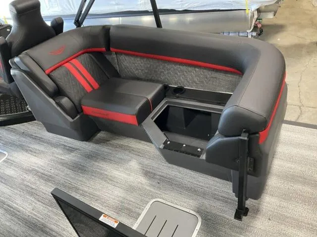 Slide: The Image of 2025 Bennington 24 MFB boat seating with red and gray upholstery and storage compartment. - 12