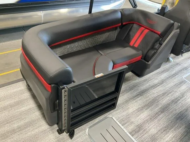 Slide: The Image of 2025 Bennington 24 MFB boat interior with sleek black and red seating. - 13