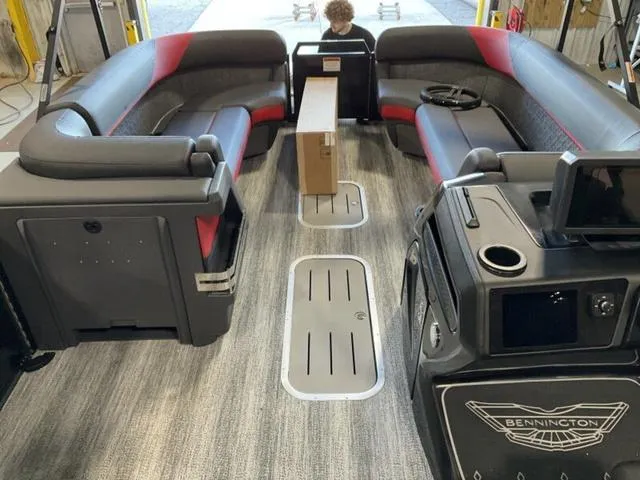 Slide: The Image of 2025 Bennington 24 MFB boat interior with modern seating and control panel. - 14