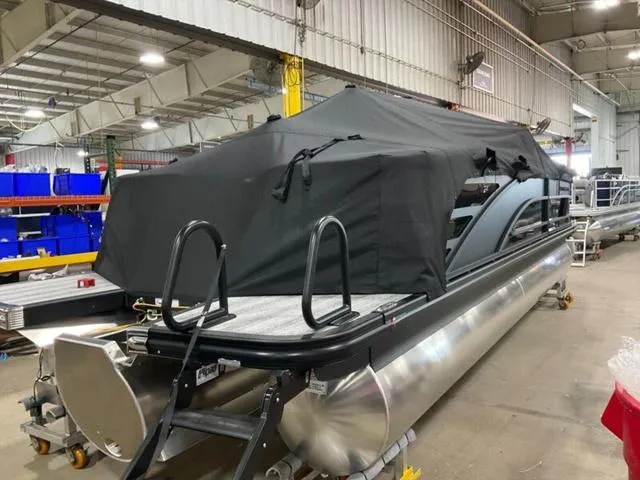 Slide: The Image of 2025 Bennington 24 MFB pontoon boat covered in a warehouse setting. - 27