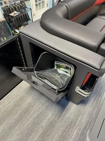 Slide: The Image of 2025 Bennington 24 MFB boat storage compartment with open door and interior items. - 29