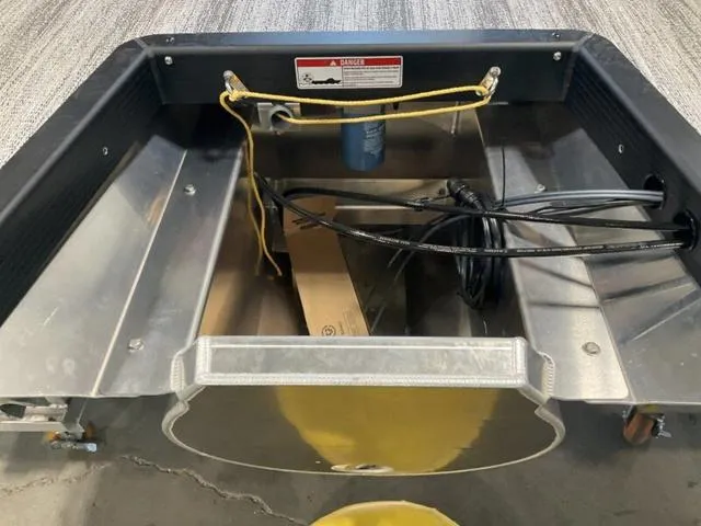 Slide: The Image of Bennington 24 MFB 2025 boat storage compartment with cables and equipment. - 6