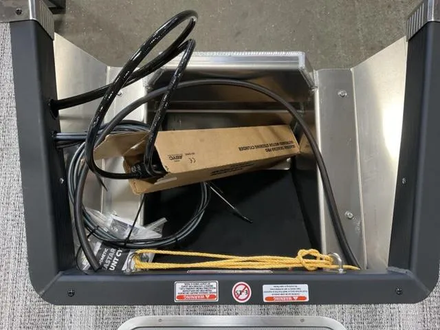 Slide: The Image of 2025 Bennington 22SSB-SPS pontoon boat interior with gray seating and blue accents. - 10