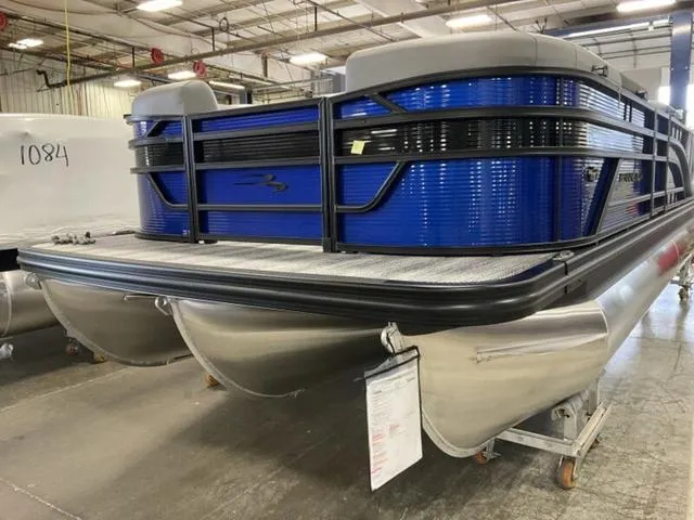 Slide: The Image of 2025 Bennington 22SSB-SPS pontoon boat in a warehouse setting. - 3