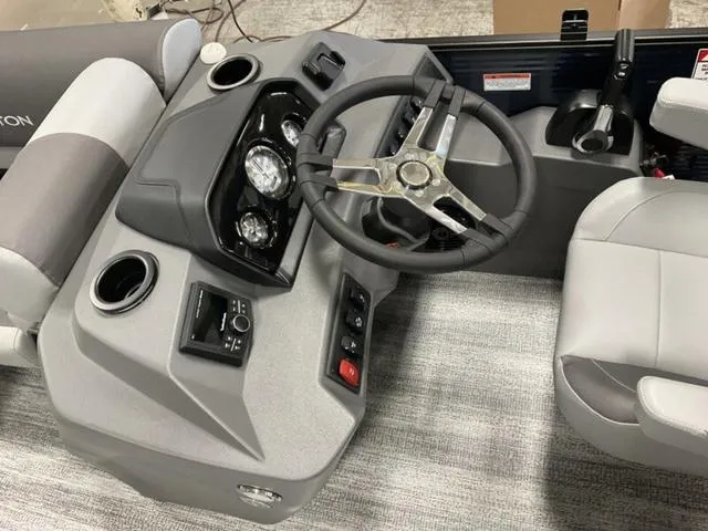 Slide: The Image of 2025 Bennington 22 SSR boat dashboard with steering wheel and control panel. - 11