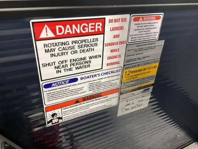 Slide: The Image of Warning labels on a 2025 Bennington 22 SSR boat, highlighting safety precautions and capacity limits. - 12