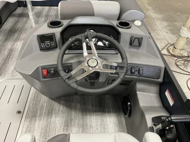 Slide: The Image of 2025 Bennington 22 SSR boat dashboard with steering wheel and controls. - 13