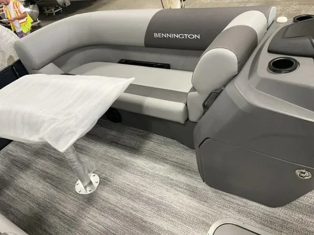 Slide: The Image of 2025 Bennington 22 SSR boat interior with gray seating and table. - 16
