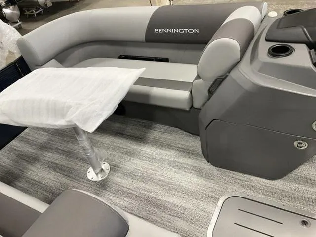 Slide: The Image of 2025 Bennington 22 SSR boat interior with gray seating and table. - 19