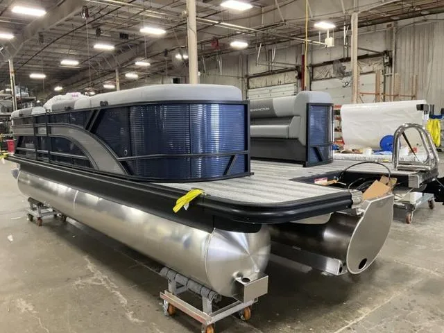 Slide: The Image of 2025 Bennington 22 SSR pontoon boat cruising on a lake with passengers. - 3