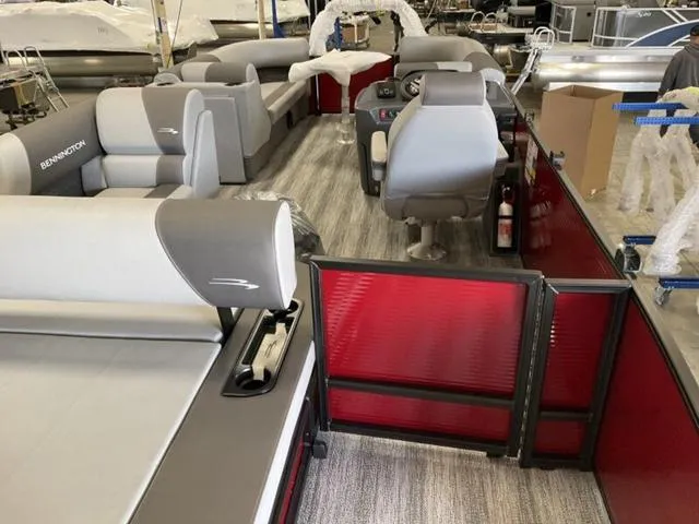 Slide: The Image of 2025 Bennington 23 SSB pontoon boat interior with gray seating and red accents. - 12