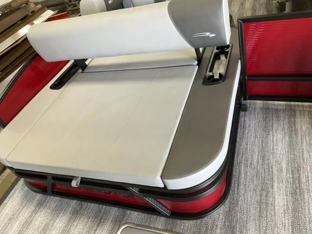 Slide: The Image of 2025 Bennington 23 SSB boat interior with red and gray seating. - 13