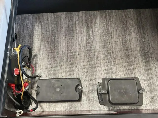 Slide: The Image of Interior view of 2025 Bennington 23 SSB boat, showing battery compartments and wiring. - 14