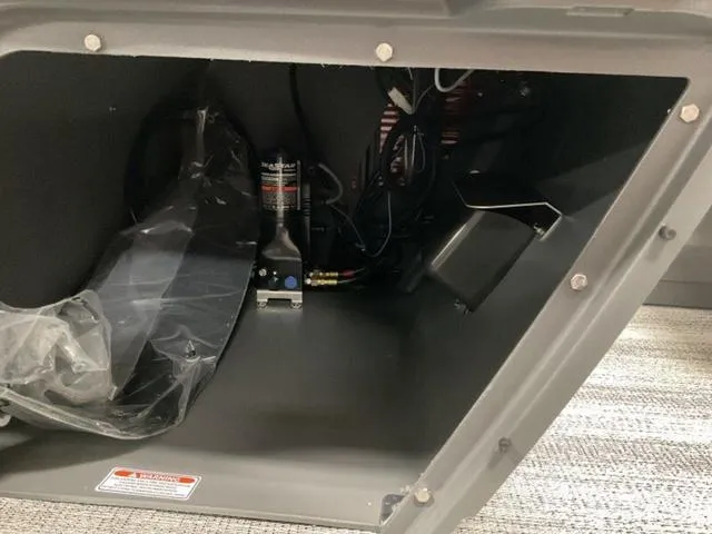 Slide: The Image of 2025 Bennington 23 SSB interior compartment with wiring and components. - 18