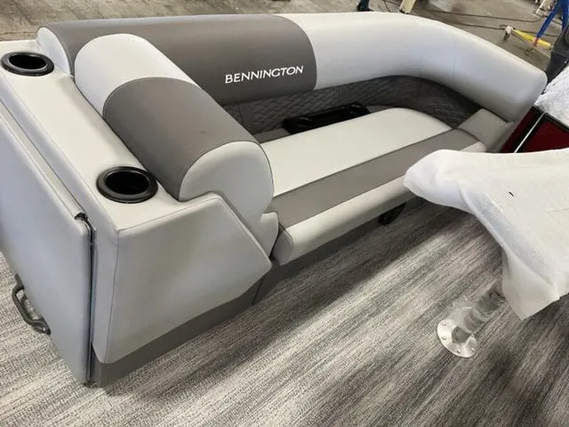 Slide: The Image of 2025 Bennington 23 SSB boat seating with gray upholstery and cup holders. - 20