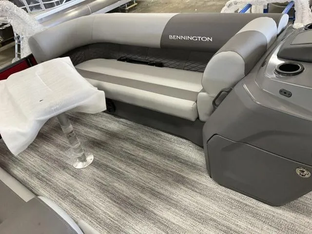 Slide: The Image of 2025 Bennington 23 SSB boat interior with gray seating and table. - 21